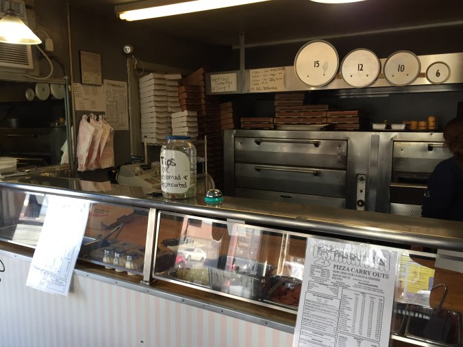 Counter, Ovens, Boxes, Pans, Register, and Worker at Pasquale's 16th