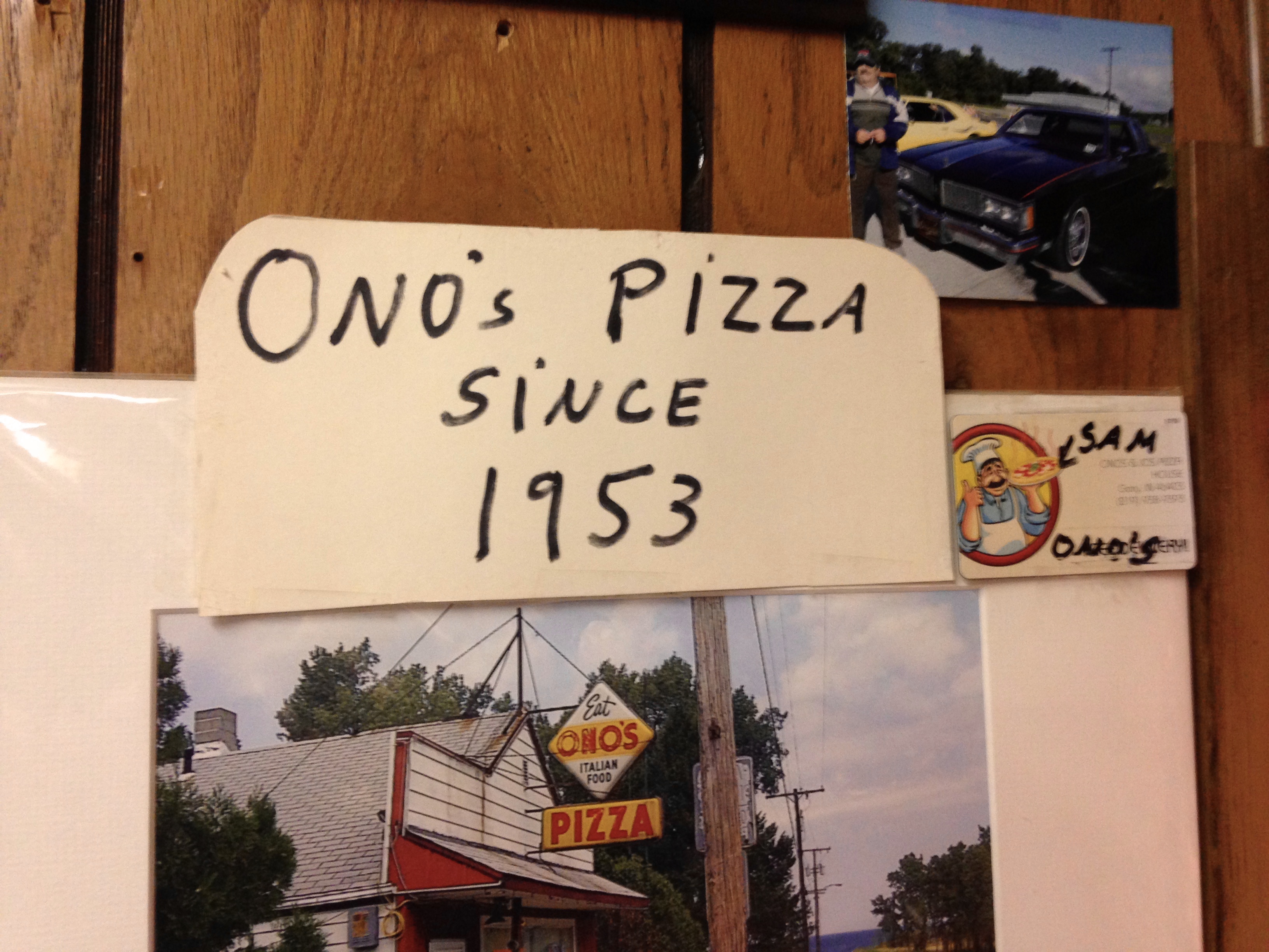 Handwritten Sign Stating "Ono's Pizza Since 1953," with Business Card and Photo of Sam and His Car